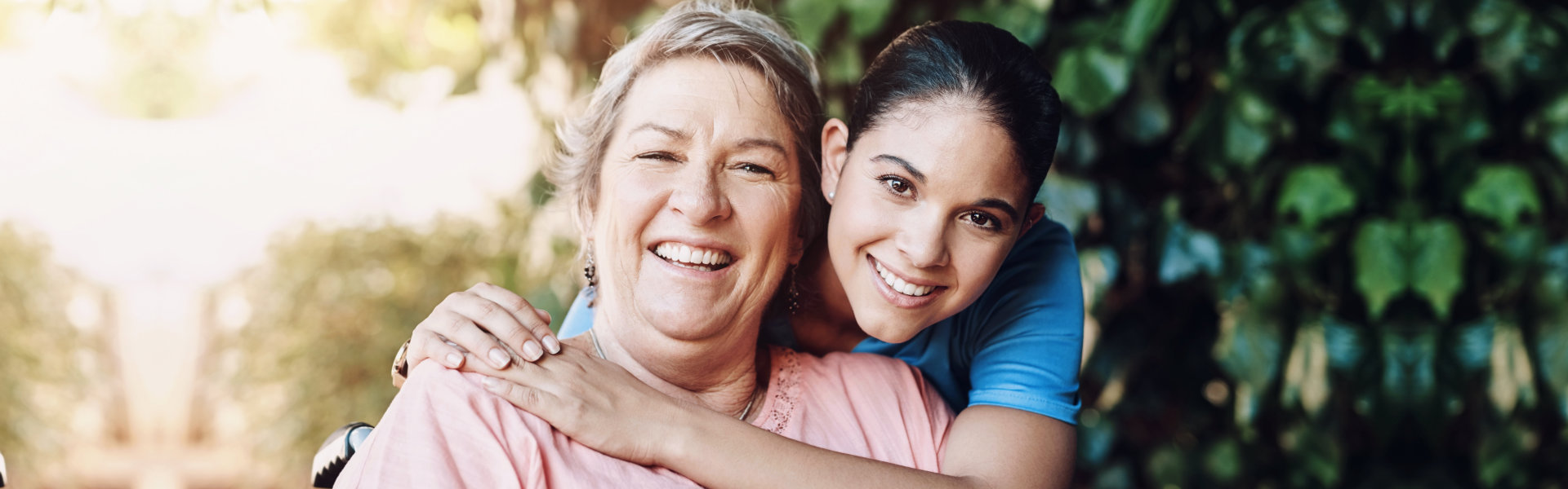 caregiver hugging the elder woman